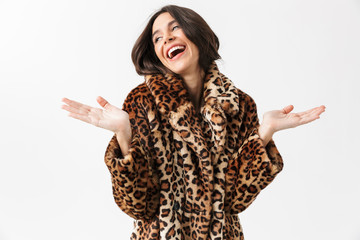 Beautiful woman wearing leopard fur coat