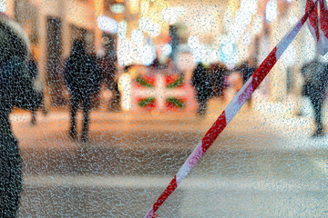 Texture and close up of shattered broken glass and silhouettes of people