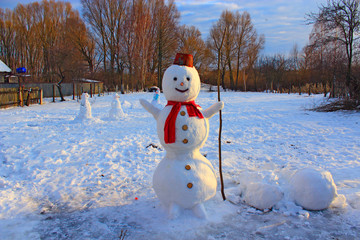 Snowman joyful. Christmas snowman made in garden
