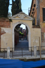 Beautiful Interior Courtyard Seen From Beautiful Small Canal Through An Archway In Venice. Travel, holidays, architecture. March 28, 2015. Venice, Veneto region, Italy.