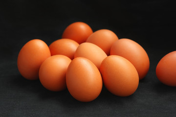 Brown chicken eggs isolated on black, selective focus