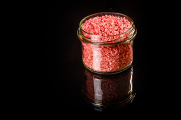 top view small glass jar with pink organic sea salt