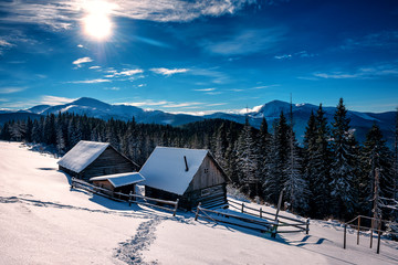 two wooden hut (cabins) in winter