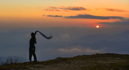 A young woman standing on mountain