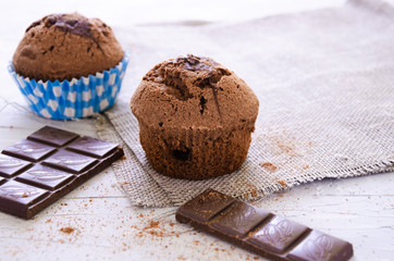 chocolate cupcake with cream, powdered sugar and berries