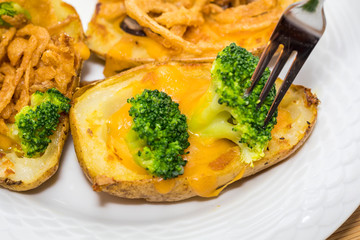 Potato Skins appetizer with broccoli, cheddar cheese and fried onions