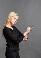 Obraz premium surprised girl writes in tablet