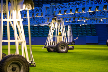 Mobile grow lighting system in sports stadium at night.