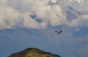 A passenger airplane flying over the mountains