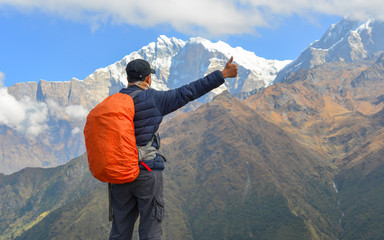 Young trekker looking at snow mountain