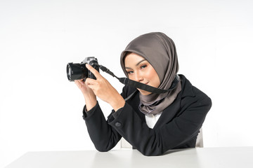 Hijab businesswoman holding the camera with white background.