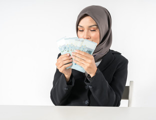 Hijab businesswoman and money with white background. Focused at money.