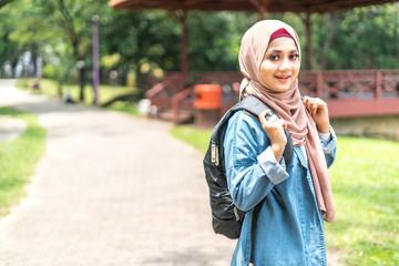 Veiled teenager at outdoor park.