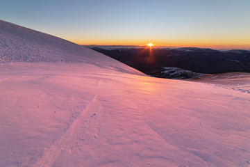 Mountain winter landscape in the Ukrainian Carpathians on the background of the sunset.