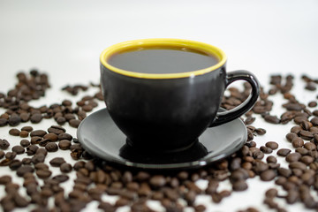 A cup of coffee on coffee beans background. Selective focus.