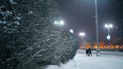 Snowfall in night winter city. Yekaterinburg, Russia. Slow motion.