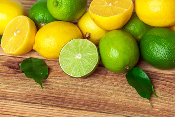 Fototapeta na wymiar lemons and limes on wooden pad