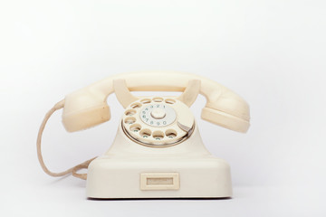 Old telephone on the white background