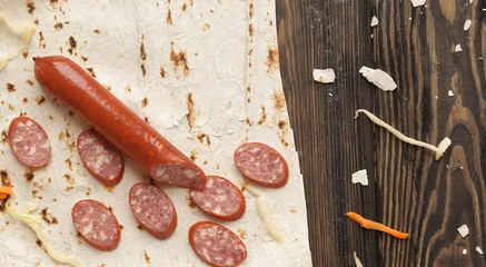 ingredients for cooking burrito on a wooden table