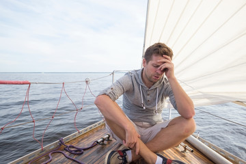 young european man having a nausea seasickness. He is trying to stop vomiting. - obrazy, fototapety, plakaty