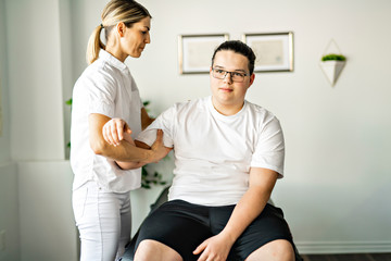 A Modern rehabilitation physiotherapy woman worker with client
