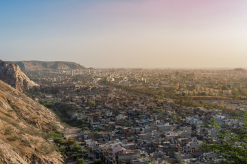 Obraz premium Aerial view of Jaipur cityscape from the sun temple view point near Galtaji Temple or the Monkey Palace in senset moment, Jaipur, Rajasthan, India