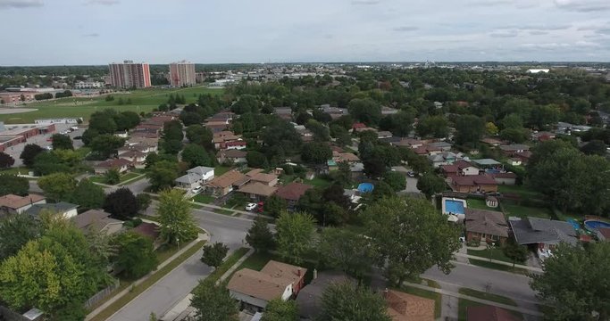 Flying To The Left Over Neighborhood And City In Distance
