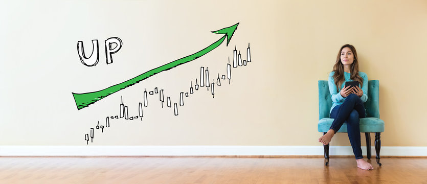 Market up trend chart with young woman holding a tablet computer