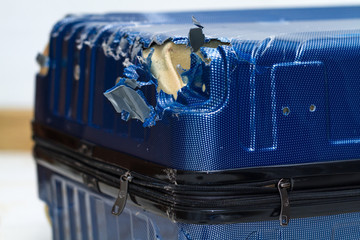 Traveling suitcase damaged at the airport. Broken luggage wheel