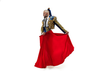 Torero in blue and gold suit or typical spanish bullfighter isolated over white studio background. The taming, achieving the goal, mortification, conquest, boss, leadership, battle, win, winner