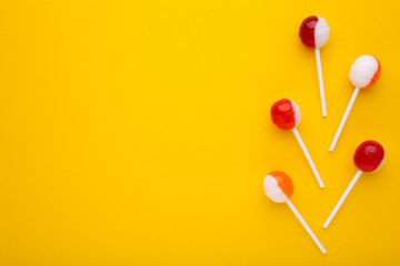 Sweet lollipops on yellow background. sweet candy concept