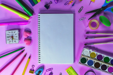 office supplies - pencils, pens, paints, brushes, scissors. notebook. place for text.