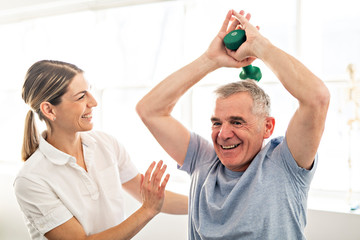 A Modern rehabilitation physiotherapy worker with senior client