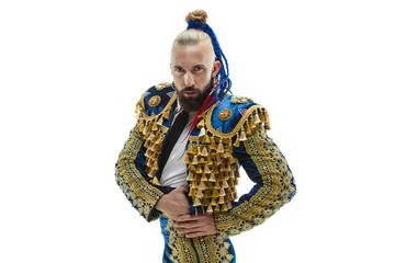 Torero in blue and gold suit or typical spanish bullfighter isolated over white studio background. The taming, achieving the goal, mortification, conquest, boss, leadership, battle, win, winner