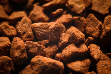 Granules of instant coffee texture background. Macro close-up photography.
