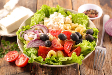 mixed salad with pasta, tomato, olive and cheese