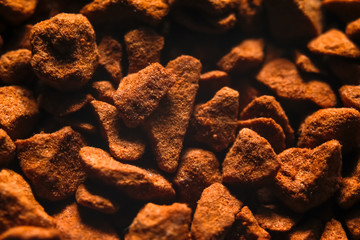 Granules of instant coffee texture background. Macro close-up photography.