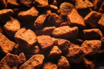 Granules of instant coffee texture background. Macro close-up photography.