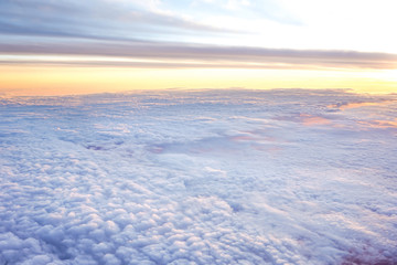 Fototapeta na wymiar Sunny sky abstract background,Beautiful cloudscape on the atmosphere heaven.Scenic view sunrise over white fluffy clouds from the airplane window.Freedom,Nature,Backdrop Concept.Copy space for text.