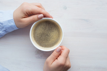 Female hands with coffee drink