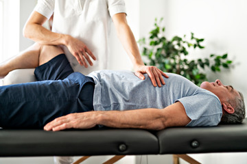 A Modern rehabilitation physiotherapy worker with senior client