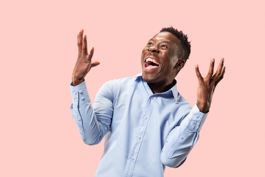 I won. Winning success happy man celebrating being a winner. Dynamic image of afro male model on pink studio background. Victory, delight concept. Human facial emotions concept. Trendy colors - Powered by Adobe