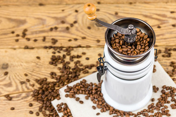Vintage coffee grinder mill with coffee beans.