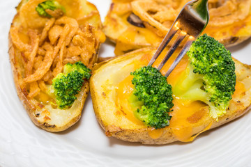 Potato Skins appetizer with broccoli, cheddar cheese and fried onions