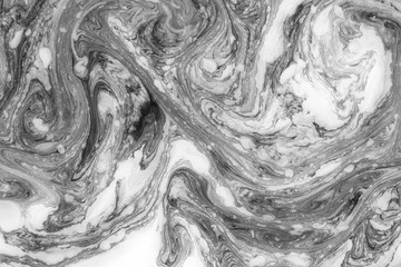Abstract monochrome marble background. Stains of paint on the surface of the water.