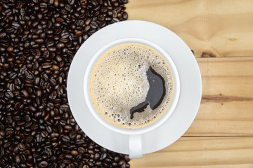 Top view. White cup of coffee on wood