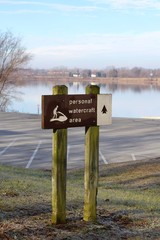 A old brown wooden park sign post on a close view.