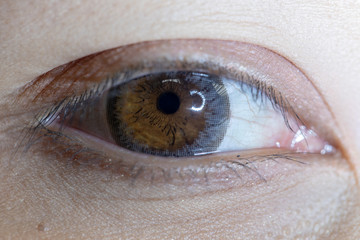 Close up of beautiful woman eye and contact lens. 