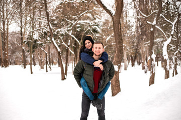 Happy couple have fun in winter park.