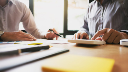 team of business collaboration working on spreadsheets calculating a value of stock market exchange.